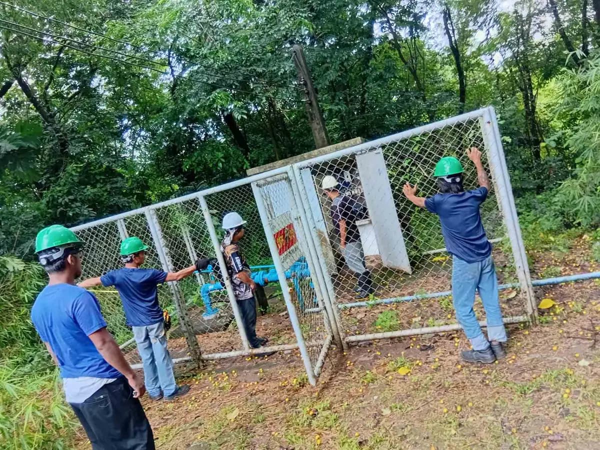 Wattsavers crew at a fenced pump house and valve manifold