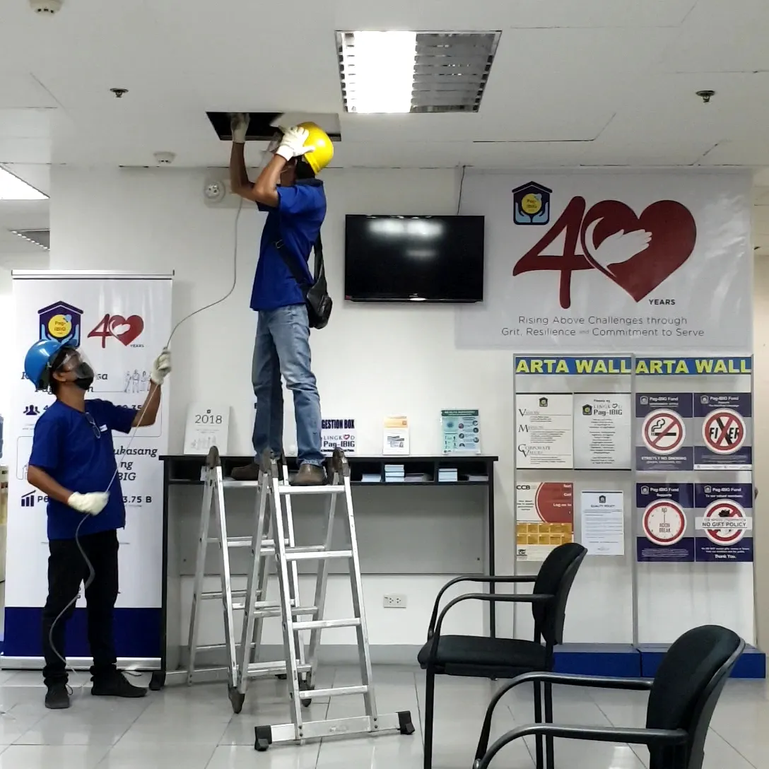 Wattsavers technicians running cable above a branch office ceiling